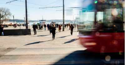 backlit-red-bus-and-people-walking-in-the-street-picture-id515886140.jpg