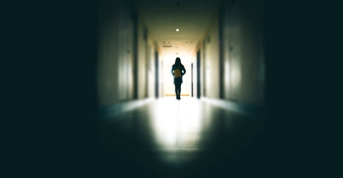 young-woman-in-dark-building-walkway-picture-id915612910.jpg